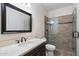 This bathroom boasts a tile shower, framed mirror, modern sink, and neutral-colored walls at 10626 E Voax Dr, Sun Lakes, AZ 85248