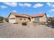 Attractive single-story home with a well-manicured yard featuring desert landscaping and a red tile roof at 10626 E Voax Dr, Sun Lakes, AZ 85248