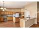 Well-lit kitchen with wooden cabinetry, granite countertops, and a center island at 10626 E Voax Dr, Sun Lakes, AZ 85248