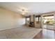 Spacious living room featuring a modern fireplace, a ceiling fan, and access to the patio at 10626 E Voax Dr, Sun Lakes, AZ 85248