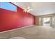 Bright living room featuring neutral carpet, ceiling fan, and access to a patio at 10626 E Voax Dr, Sun Lakes, AZ 85248