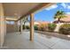 This covered patio features a large area for outdoor activities with desert landscaping at 10626 E Voax Dr, Sun Lakes, AZ 85248