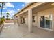 This large covered patio includes columns, a stamped concrete floor, and sliding glass doors at 10626 E Voax Dr, Sun Lakes, AZ 85248