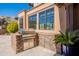 Outdoor kitchen with stainless steel grill and stonework at 10712 E Greythorn Dr, Scottsdale, AZ 85262