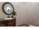 Elegant powder room with ornate vanity and floral wallpaper at 10712 E Greythorn Dr, Scottsdale, AZ 85262