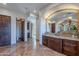 Elegant bathroom with double vanity, large mirror, and tile flooring at 10712 E Greythorn Dr, Scottsdale, AZ 85262