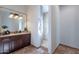 Elegant bathroom with a walk-in shower and dark wood vanity at 10712 E Greythorn Dr, Scottsdale, AZ 85262