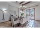 Elegant dining room features a chandelier, large windows and seating for eight at 10712 E Greythorn Dr, Scottsdale, AZ 85262