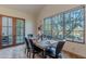 Elegant dining room with a wooden table, six chairs and access to a private patio at 10712 E Greythorn Dr, Scottsdale, AZ 85262