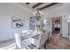 Formal dining room with a rustic wooden table and access to the kitchen at 10712 E Greythorn Dr, Scottsdale, AZ 85262