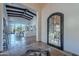 View of entryway with tile flooring, arched door, and view into living room at 10712 E Greythorn Dr, Scottsdale, AZ 85262