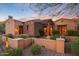 Stunning exterior with stone facade and desert landscaping at 10712 E Greythorn Dr, Scottsdale, AZ 85262