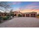 Beautiful desert home with a large driveway, mature trees, and sunset views at 10712 E Greythorn Dr, Scottsdale, AZ 85262