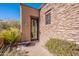 Inviting entryway with stonework and landscaping, leading to a charming home at 10712 E Greythorn Dr, Scottsdale, AZ 85262