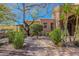 Pathway to inviting front entrance with mature trees and xeriscaping at 10712 E Greythorn Dr, Scottsdale, AZ 85262