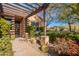 Landscaped front yard with a pergola and brick pathway at 10712 E Greythorn Dr, Scottsdale, AZ 85262