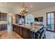 Island kitchen with granite countertops and dark wood cabinets at 10712 E Greythorn Dr, Scottsdale, AZ 85262