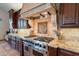 Kitchen features professional grade range and custom cabinetry at 10712 E Greythorn Dr, Scottsdale, AZ 85262