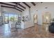 Bright living room with high ceilings, exposed beams, and tiled floor at 10712 E Greythorn Dr, Scottsdale, AZ 85262