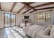 Main bedroom with wood beams, fireplace, and French doors leading to pool at 10712 E Greythorn Dr, Scottsdale, AZ 85262