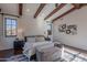 Main bedroom with wood beams, large windows, and plush bedding at 10712 E Greythorn Dr, Scottsdale, AZ 85262