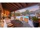 Outdoor patio dining area with pool and mountain views at 10712 E Greythorn Dr, Scottsdale, AZ 85262