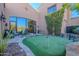 Private putting green with flag and surrounding landscaping at 10712 E Greythorn Dr, Scottsdale, AZ 85262