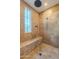 Spa-like shower with built-in bench and rainfall showerhead at 10712 E Greythorn Dr, Scottsdale, AZ 85262