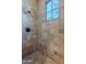 Shower with tiled walls and a window for natural light at 10712 E Greythorn Dr, Scottsdale, AZ 85262