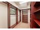 Bright walk-in closet, built-in shelving and drawers at 10712 E Greythorn Dr, Scottsdale, AZ 85262