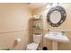 Small bathroom with pedestal sink, toilet and decorative mirror at 11618 W Olive Dr, Avondale, AZ 85392