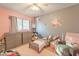 Pastel-toned bedroom with toddler bed and seating area at 11618 W Olive Dr, Avondale, AZ 85392