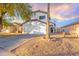 Two-story house with a white exterior, a two-car garage, and a landscaped front yard at 11618 W Olive Dr, Avondale, AZ 85392