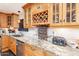 Kitchen with granite countertops, wood cabinets, and a wine rack at 11618 W Olive Dr, Avondale, AZ 85392