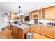 Kitchen with island, granite countertops, and ample wood cabinets at 11618 W Olive Dr, Avondale, AZ 85392