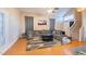 Living room with hardwood floors, a sectional sofa, and a large window at 11618 W Olive Dr, Avondale, AZ 85392