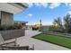 Outdoor patio with putting green and stunning desert mountain views at 11952 E Casitas Del Rio Dr, Scottsdale, AZ 85255