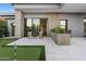 Private backyard with putting green and patio seating area at 11952 E Casitas Del Rio Dr, Scottsdale, AZ 85255