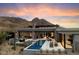 Luxury home with pool and mountain views at sunset at 11952 E Casitas Del Rio Dr, Scottsdale, AZ 85255