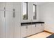 Laundry room with white cabinets and dark countertops at 11952 E Casitas Del Rio Dr, Scottsdale, AZ 85255