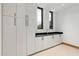 Modern laundry room with white cabinets and dark countertop at 11952 E Casitas Del Rio Dr, Scottsdale, AZ 85255