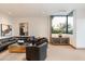 Modern living room with leather furniture and large window at 11952 E Casitas Del Rio Dr, Scottsdale, AZ 85255