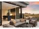 Modern outdoor kitchen with seating area and desert views at 11952 E Casitas Del Rio Dr, Scottsdale, AZ 85255