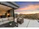 Patio furniture with desert landscape view and partial kitchen view at 11952 E Casitas Del Rio Dr, Scottsdale, AZ 85255