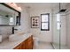 Modern bathroom with marble tile, walk-in shower, and updated vanity at 12026 N 138Th St, Scottsdale, AZ 85259