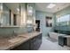 Modern bathroom with a double vanity, walk-in shower, and a large mirror at 12026 N 138Th St, Scottsdale, AZ 85259