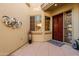 Front entry with a rich wood door and decorative metal wall art at 12026 N 138Th St, Scottsdale, AZ 85259