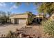 Tan stucco house with two-car garage, landscaping, and a paved driveway at 12026 N 138Th St, Scottsdale, AZ 85259