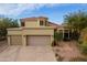 Two-story home with two-car garage and desert landscaping at 12026 N 138Th St, Scottsdale, AZ 85259