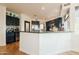 Modern kitchen with dark cabinetry and stainless steel appliances at 12026 N 138Th St, Scottsdale, AZ 85259